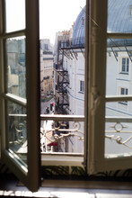 View Of A Street And Buildings In Paris Through An Open Window