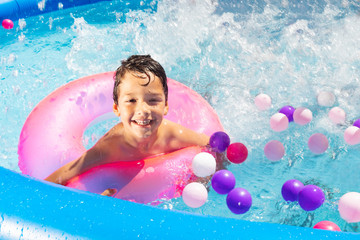 Wall Mural - Boy swim splash with buoy ring in swimming pool