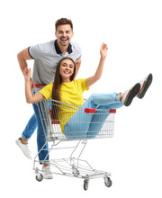 Young Couple With Shopping Cart On White Background