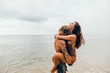 © Andrey Pavlov/Stocksy - A young couple have fun at the beach