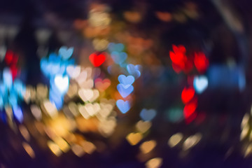 Аbstract sweet colorful heart shaped bokeh. Street light blurred background. Valentine's day and love concept