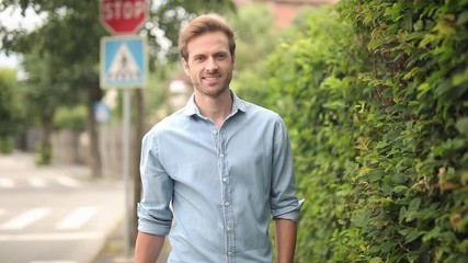 Poster - happy casual man walks and shows blank speech bubbleand makes the ok sign