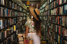 Beautiful Girl Wearing Stylish Outfit Looking For Interesting Book In The Vintage Bookstore