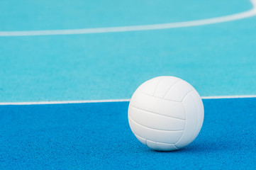 Wall Mural - Volleyball ball on blue playground with white line