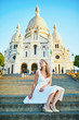 woman in white dress walking on famous Montmartre hill in Paris