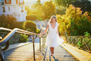 Wall Mural - woman in white dress walking on famous Montmartre hill in Paris