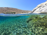 Fototapeta Most - Above and below underwater photo of crystal clear sea paradise rocky seascape of Laki beach in Kato Koufonisi island, Cyclades, Greece