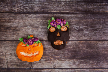 Sticker - Hand painted gingerbread cookie scary Halloween old jack-o-lantern pumpkin and skull on wooden background. Top view