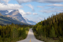 Scenic Road In The Canadian Rockies During A Vibrant Sunny And Cloudy Summer Morning. Taken In Icefields Parkway, Banff National Park, Alberta, Canada.