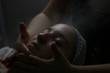 Spa facial treatment being applied to young woman 