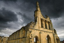 Medieval Great Church Ruins Of Byland Abbey North Yorkshire England With Dark Storm Clouds At Sunset