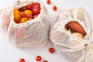 Zero waste concept. Fresh organic vegetables in textile bag on a white background.