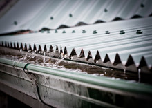 Rain On A Corrugated Iron Roof Collecting In A Gutter
