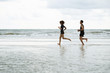 © only_kim - Runners. Young people running on beach. Athletic attractive people jogging on beach enjoying the sun exercising their healthy lifestyle.