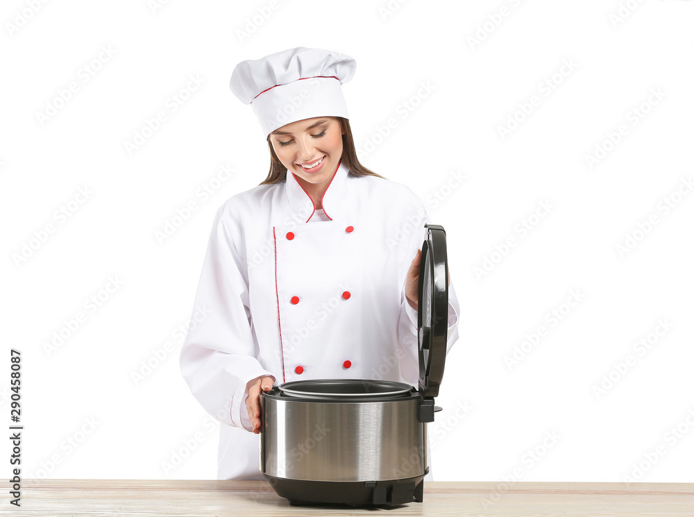 Female chef with modern multi cooker on white background