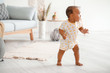 © Pixel-Shot - Cute little baby learning to walk at home