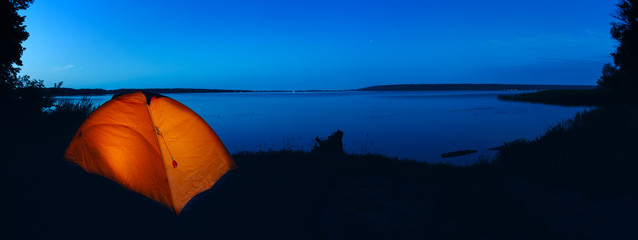 Wall Mural - orange lighted tent on lake