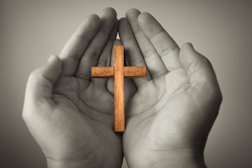 Cross in palm of hand. Religion and faith concept. 