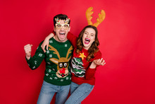 Photo Of Excited Pair Lady And Guy Chilling At Newyear Theme Costume Party Wear Funky Knitted Pullovers With Ornaments Isolated Red Color Background
