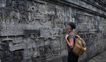 Tourist Backpacker Exploring The Borobudur Temple In Java Island,Indonesia