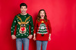 Portrait of astonished two people wife with brunette hair scream wow enjoy deer christmas pattern fashion jumper wear denim jeans stylish trendy pullover isolated over red color background