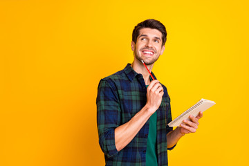 Poster - Photo of nice guy with organizer in hands making notes creating startup idea wear casual checkered shirt isolated yellow color background