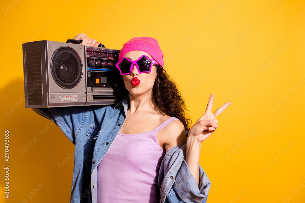 Photo of flirty lady with tape recorder on shoulder showing v-sign sending air kiss wear casual trendy clothes isolated yellow color background - obrazy, fototapety, plakaty 