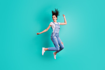 Full length body size view of her she nice attractive cheerful cheery glad carefree girl wearing overall jumping having fun free time isolated on bright vivid shine vibrant green turquoise background