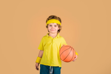 Kid holds basketball. Kid playing with basketball. Sport for children. Hobby sport concept. Sporty boy with ball. Sport active. Boy in sportswear. Sport, fitness, healthy lifestyle. Basketball player.