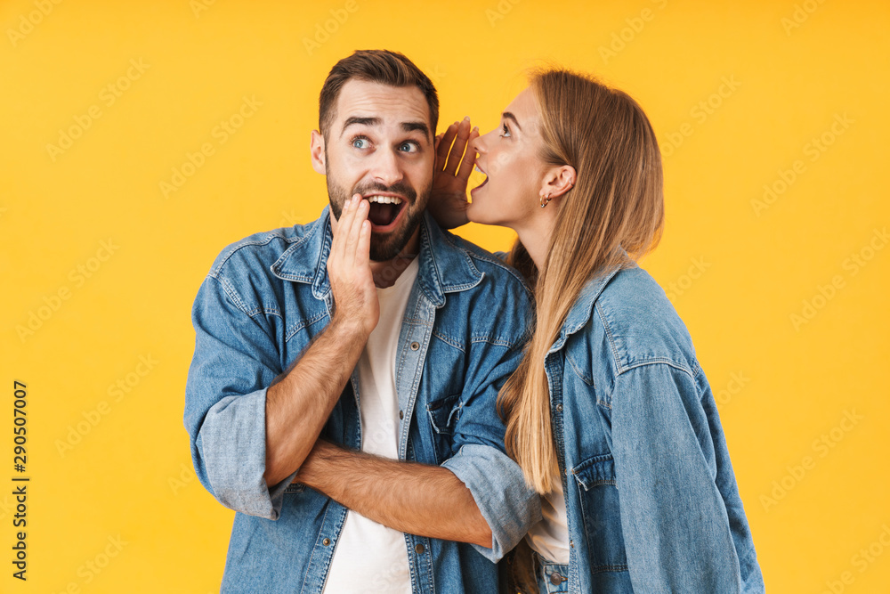 Image of happy woman whispering secret to excited man in his ear - obrazy, fototapety, plakaty 