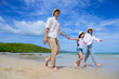 © ID_Anuphon - Parent father and mother help to holding hand of kid, care and always support to success destination of life, enjoy hold hand together on the sea beach