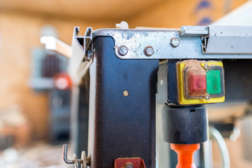 Sticker - On off switch on table saw close up shot, shallow depth of field, copy space.