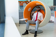 © Mangostar - Peaceful businessman in VR headset enjoying virtual video. Man in office clothes and virtual reality goggles sitting in interactive chair and relaxing. Virtual content watching concept