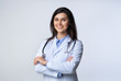 © Prostock-studio - Cheerful doctor standing crossing hands in studio