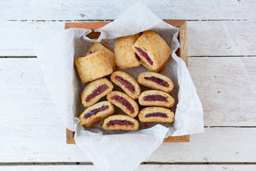 Newtons cookies inside a wooden box on a white wooden table