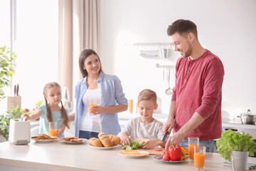 Wall Mural - Happy family having breakfast with toasts in kitchen