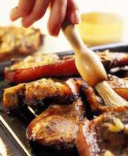 Basting Meat Chops With Hand Holding Basting Brush