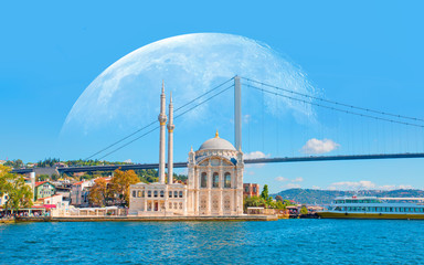 Ortakoy mosque and Bosphorus bridge with full moon - Istanbul, Turkey 