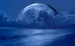 © muratart - Night sky with moon in the clouds on the foreground blue sea'Elements of this image furnished by NASA