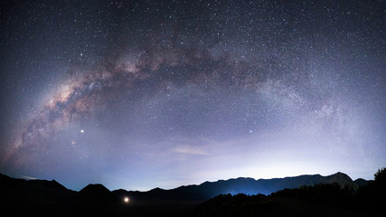 Beautiful night landscape with silhouette of Bromo mountain on the background Milky way galaxy - Bromo Tengger Semeru National Park , Indonesia