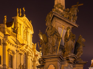 Wall Mural - Prague - The baroque column of Holy Trinity and tower and facade of St. Nichlas church at the night.