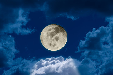  Big bright and shining full moon against a dark night sky dramatic seen through a hole in the clouds. Elements of this image furnished by NASA