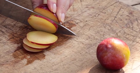 Wall Mural - Cutting plums in thin slices