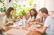 © Krakenimages.com - Beautiful family sitting on terrace eating foods speaking and smiling