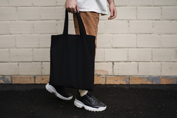 Wall Mural - Man holding cotton Black Tote bag