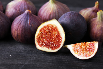 Wall Mural - Fresh figs. Food Photo. whole and sliced figs on beautiful rustic background.