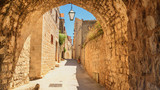 Fototapeta Uliczki - Mediterranean summer cityscape - view of a medieval street in the Old Town of Hvar, on the island of Hvar, the Adriatic coast of Croatia