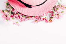 Summer Elegant Composition. Beautiful Pink Daisy Flowers And Pink Wicker Hat On White Background. Summer Concept. Flat Lay, Top View, Copy Space