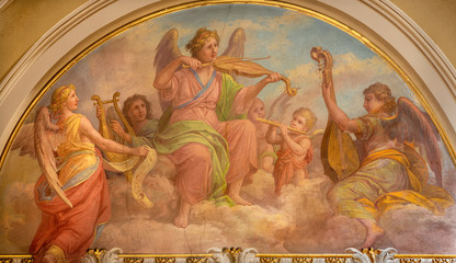 MENAGGIO, ITALY - MAY 8, 2015: The fresco of choir of angels wiht the music instruments in church chiesa di Santo Stefano by Luigi Tagliaferri (1841-1927).