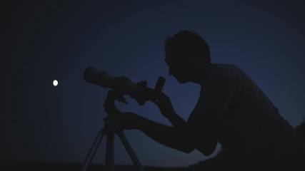 Wall Mural - astronomer with a telescope watching at the stars and moon. my astronomy work.